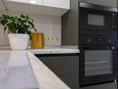 Marble worktop of modern white and dark grey kitchen
