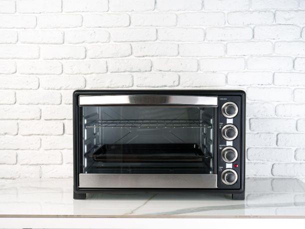 mini electric oven againsta a white tiled background