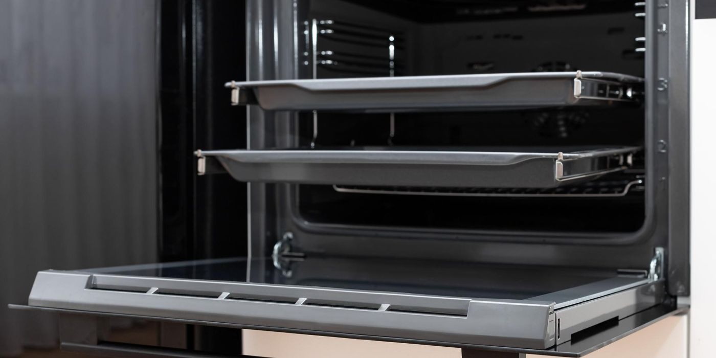 Open integrated oven with the racks on sliding rails and they are pulled out