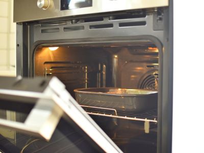 oven door open and the light inside is on showcasing a clen oven