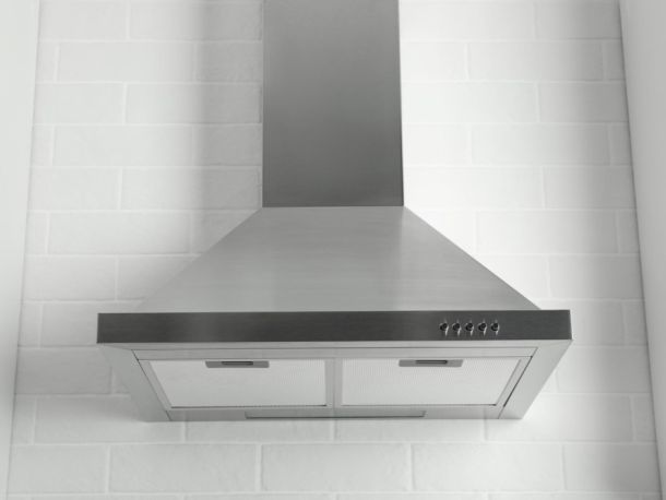 silver cooker hood against a white tiled wall